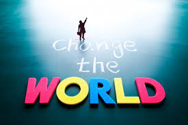 The word change the world with a person standing on top of it.